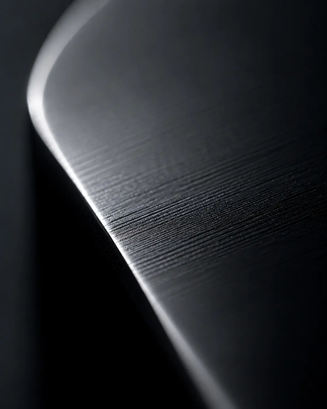 Macro view of a refined metal surface with a dark industrial finish