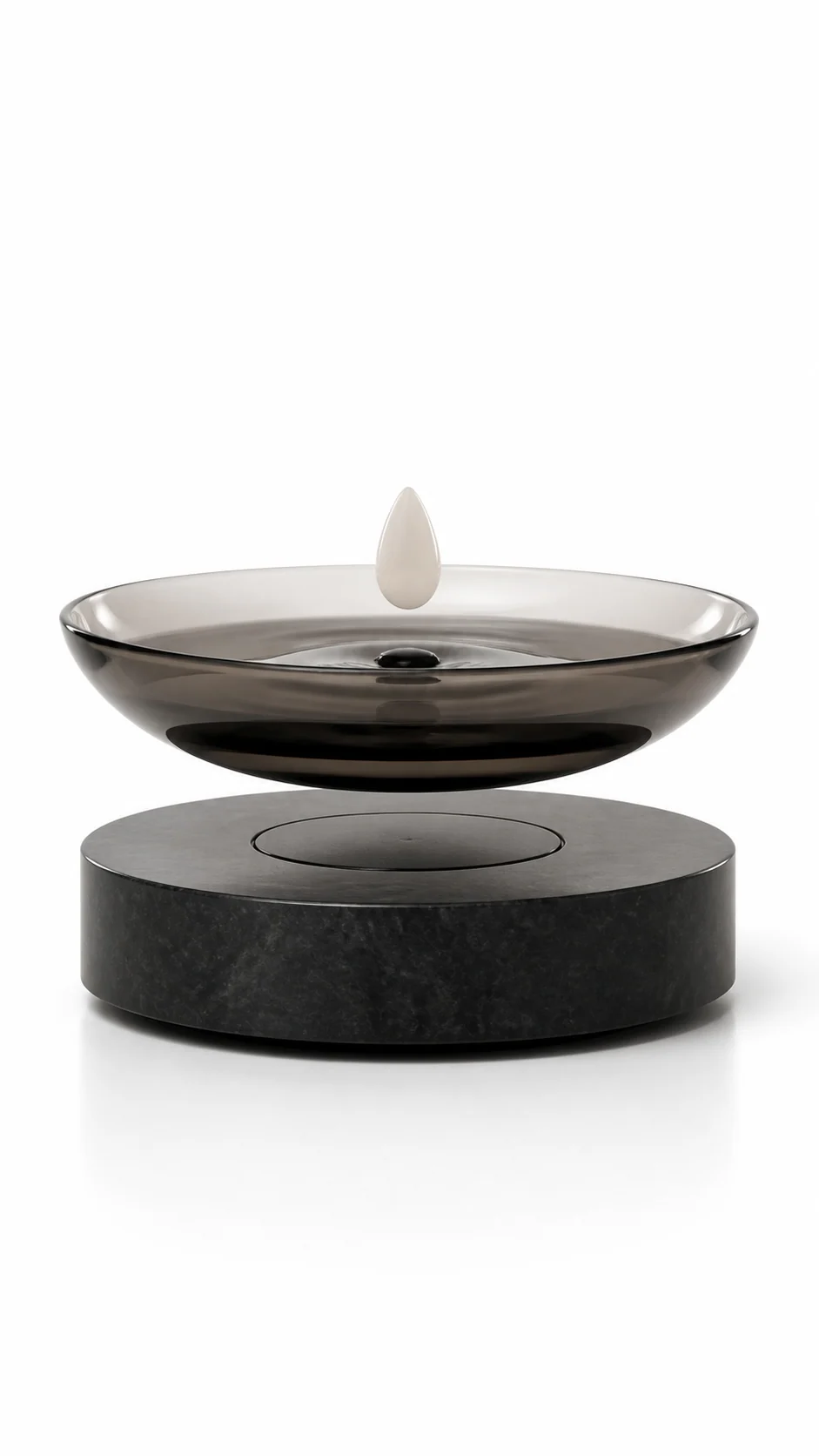 Smoked-glass levitating basin with a floating white droplet on a dark stone base