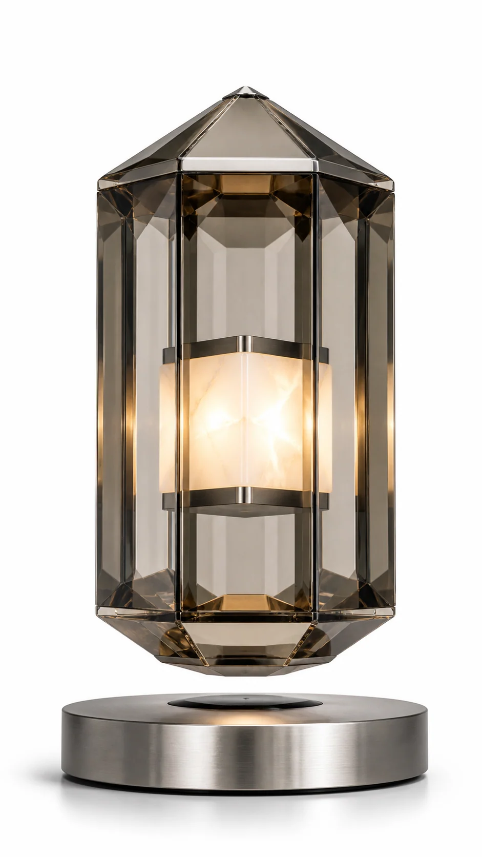 AMO Noctis Prism Lamp with a smoky faceted shell and warm alabaster-like glowing core above a brushed metal base